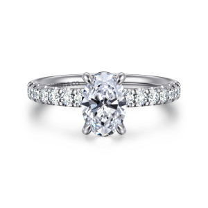 Gabriel & Co. ER16572O4W44JJ 14 karat white gold Contemporary engagement ring, front view of an oval center in slender claw prongs with diamonds reaching the base of the head