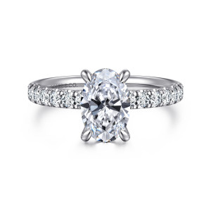 Gabriel & Co. ER16572O6PT4JJ platinum Contemporary engagement ring, front view of an oval center between rows of round diamonds, held by slim rounded prongs