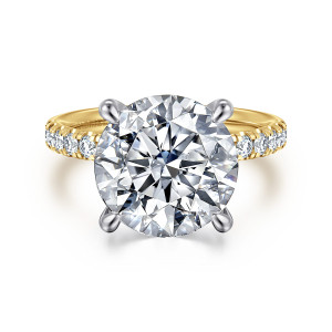 Gabriel & Co. ER16572R20M44JJ 14 karat white and yellow gold Contemporary engagement ring, front view of the round center in four rounded prongs with diamonds on the warmer toned band