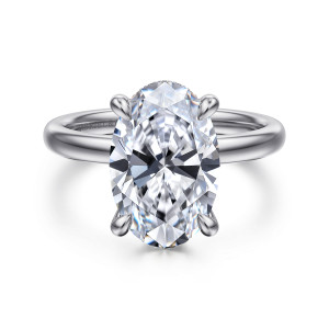Gabriel & Co. ER16618O16W44JJ 14 karat white gold Classic engagement ring, front view of an oval center held by four tapered claws on a smooth band