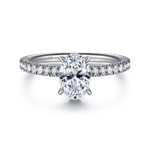 Gabriel & Co. ER16620O4W44JJ 14 karat white gold Classic engagement ring, front view of an oval center on claw prongs with round diamonds along both shoulders