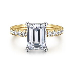 Gabriel & Co. ER16621E10M44JJ 14 karat white and yellow gold Contemporary engagement ring, front view of an emerald cut center in claw prongs with small round stones running down the shoulders