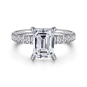 Gabriel & Co. ER16621E8W44JJ 14 karat white gold Contemporary engagement ring, front view of an emerald cut center with teardrop claw prongs and small diamonds along both shoulders