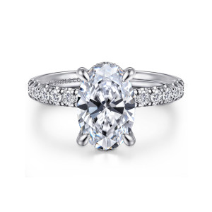 Gabriel & Co. ER16621O8W44JJ 14 karat white gold Contemporary engagement ring, front view of an oval center between four claw prongs with round diamonds along the shoulders