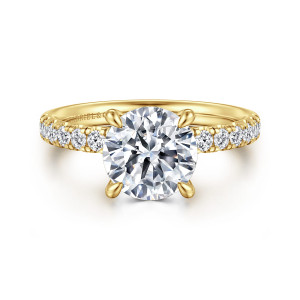 Gabriel & Co. ER16621R8Y44JJ 14 karat yellow gold Contemporary engagement ring, front view of a round center with teardrop tipped prongs and pave diamonds running along both shoulders