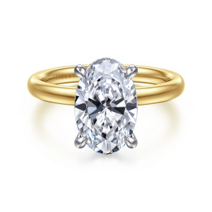 Gabriel & Co. ER16622O12M44JJ 14 karat white and yellow gold Classic engagement ring, front view of an oval center in rounded claws, with a beaded edge at the top
