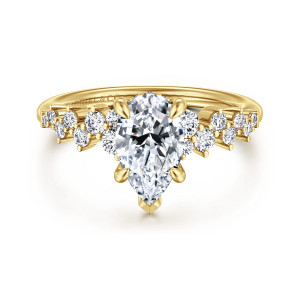 Gabriel & Co. ER16665P6Y44JJ 14 karat yellow gold Starlight engagement ring, front view of the pear shaped center between staggered round diamonds of mixed sizes on each shoulder