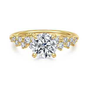 Gabriel & Co. ER16665R6Y44JJ 14 karat yellow gold Starlight engagement ring, front view of a round center flanked by staggered round stones of mixed sizes on each shoulder