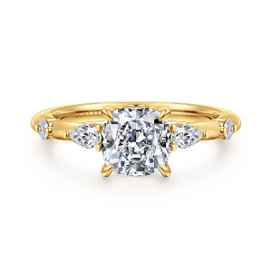Gabriel & Co. ER16666C6Y84JJ 18 karat yellow gold Starlight engagement ring, front view of a cushion cut center with spaced elongated and round stones on a slim band