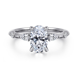 Gabriel & Co. ER16666O6PT4JJ platinum Starlight engagement ring, front view of an oval center flanked by an elongated stone and a round stone on each shoulder