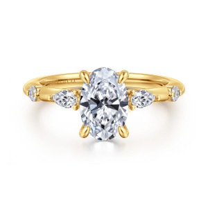 Gabriel & Co. ER16666O6Y84JJ 18 karat yellow gold Starlight engagement ring, front view of an oval center flanked by elongated and small round stones on a slim band