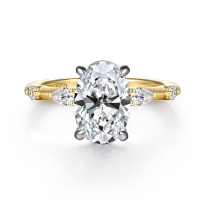 Gabriel & Co. ER16666O8M44JJ 14 karat white and yellow gold Bujukan engagement ring, front view of an oval center with elongated and round diamonds spaced along the slender band