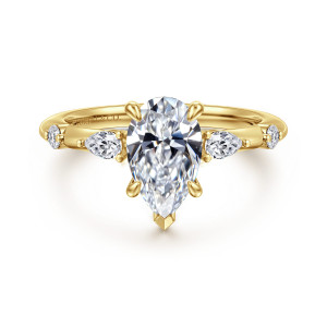Gabriel & Co. ER16666P6Y44JJ 14 karat yellow gold Starlight engagement ring, front view of a pear shaped center with a pointed prong at its tip and diamonds beside it