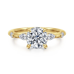 Gabriel & Co. ER16666R6Y44JJ 14 karat yellow gold Starlight engagement ring, front view of a round center with elongated stones flanking it and beads along the slender band