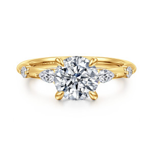 Gabriel & Co. ER16666R6Y84JJ 18 karat yellow gold Starlight engagement ring, front view of a round center between elongated side stones, each followed by a small round stone