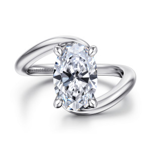 Gabriel & Co. ER16667O12W44JJ 14 karat white gold Contemporary engagement ring, front view of an oval center with one arm of the band passing across the other