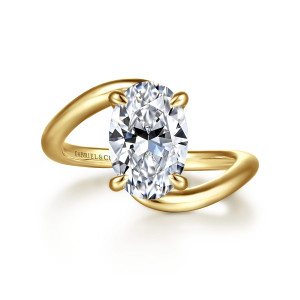 Gabriel & Co. ER16667O8Y44JJ 14 karat yellow gold Bujukan engagement ring, front view of an upright oval center in four claws between two overlapping ends of a smooth band