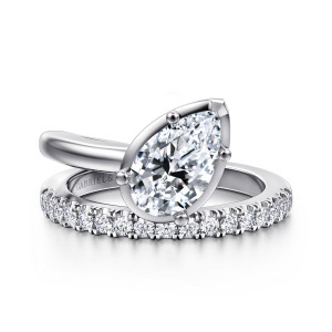 Gabriel & Co. ER16668P6W44JJ 14 karat white gold Contemporary engagement ring, front view of a tilted pear shaped center in ball tipped prongs above a strand of round stones