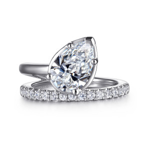 Gabriel & Co. ER16668P8W44JJ 14 karat white gold Contemporary engagement ring, front view of a pear shaped center on a slant above the stone set arm of the band