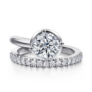 Gabriel & Co. ER16668R6W44JJ 14 karat white gold Contemporary engagement ring, front view of the round center in a thin rim with ball tipped prongs above the diamond arm