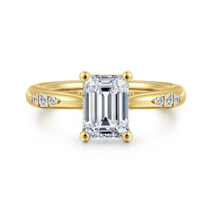 Gabriel & Co. ER16670E6Y44JJ 14 karat yellow gold Contemporary engagement ring, front view of an emerald cut center in ball tipped prongs with round diamonds on each shoulder