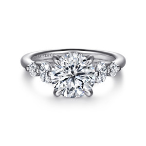 Gabriel & Co. ER16678R8W44JJ 14 karat white gold Contemporary engagement ring, front view of the round center with an elongated and a round stone on each shoulder