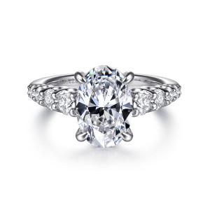Gabriel & Co. ER16679O8M44JJ 14 karat white and yellow gold Contemporary engagement ring, front view of an oval center in four prongs with round stones running down both shoulders