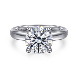 Gabriel & Co. ER16680R12W44JJ 14 karat white gold Bujukan engagement ring, front view of a round center held by four rounded prongs on a smooth broad band