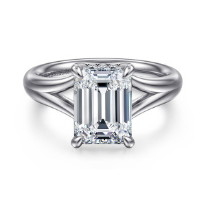 Gabriel & Co. ER16683E12W44JJ 14 karat white gold Contemporary engagement ring, front view of an emerald cut center held at its corners with the band splitting into branches