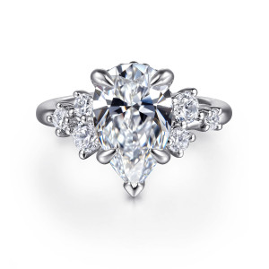 Gabriel & Co. ER16684P12W44JJ 14 karat white gold Starlight engagement ring, front view of a pear shaped center with clusters of round stones on each shoulder