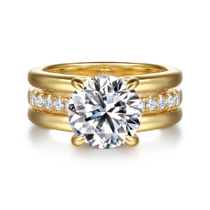 Gabriel & Co. ER16686R12Y44JJ 14 karat yellow gold Contemporary engagement ring, front view of a round center in front of a row of diamonds between two smooth rails