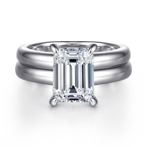 Gabriel & Co. ER16687E12W44JJ 14 karat white gold Bujukan engagement ring, front view of an emerald cut center on corner prongs above a wide, smooth, grooved band