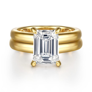 Gabriel & Co. ER16687E12Y44JJ 14 karat yellow gold Bujukan engagement ring, front view of an emerald cut center held by four rounded claws over a broad grooved band