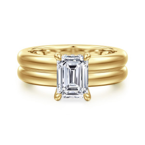 Gabriel & Co. ER16687E6Y44JJ 14 karat yellow gold Bujukan engagement ring, front view of an emerald cut center on rounded prongs above a wide band with a middle groove