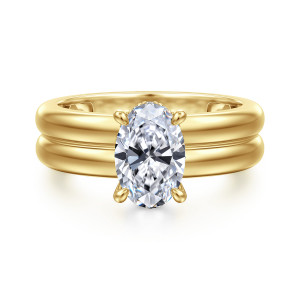 Gabriel & Co. ER16687O6Y44JJ 14 karat yellow gold Bujukan engagement ring, front view of an oval center on a wide band with a groove down the middle