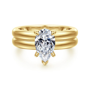 Gabriel & Co. ER16687P6Y44JJ 14 karat yellow gold Bujukan engagement ring, front view of a pear shaped center above a wide band with a groove along its face