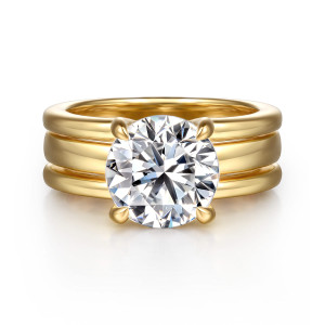 Gabriel & Co. ER16688R12Y44JJ 14 karat yellow gold Bujukan engagement ring, front view of a round center in curved prongs above a band of smooth parallel ribs