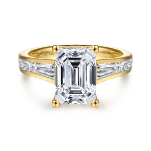 Gabriel & Co. ER16690E12Y44JJ 14 karat yellow gold Contemporary engagement ring, front view of an emerald cut center on four prongs between tapered baguettes