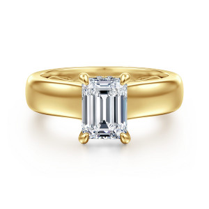 Gabriel & Co. ER16692E6Y44JJ 14 karat yellow gold Bujukan engagement ring, front view of an emerald cut center in teardrop claw prongs above a broad glossy band