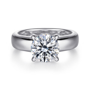 Gabriel & Co. ER16692R8W44JJ 14 karat white gold Bujukan engagement ring, front view of a round center in four prongs above a wide polished band