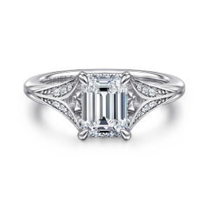 Gabriel & Co. ER16704E6W44JJ 14 karat white gold Contemporary engagement ring, front view of an emerald cut center in four claws between tapering leaf shaped shoulders