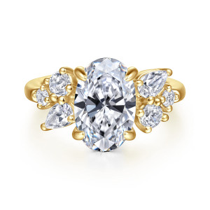Gabriel & Co. ER16705O12Y44JJ 14 karat yellow gold Starlight engagement ring, front view of an oval center with four rounded prong tips between two staggered diamond clusters