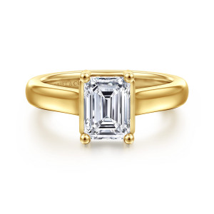 Gabriel & Co. ER16707E6Y44JJ 14 karat yellow gold Contemporary engagement ring, front view of an emerald cut center in ball tipped prongs on a smooth widening band