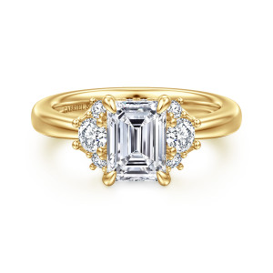 Gabriel & Co. ER16714E6Y44JJ 14 karat yellow gold Lotus engagement ring, front view of an emerald cut center between two clusters of round stones on the shoulders
