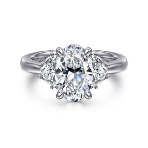 Gabriel & Co. ER16714O8W44JJ 14 karat white gold Lotus engagement ring, front view of an oval center with pointed claw prongs and a larger stone at each side