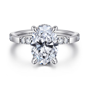 Gabriel & Co. ER16716O12W44JJ 14 karat white gold Contemporary engagement ring, front view of an oval center between clusters of small diamonds on a slim band
