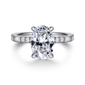 Gabriel & Co. ER16716O8W44JJ 14 karat white gold Contemporary engagement ring, front view of an oval center with short groups of small round diamonds beside it on the band