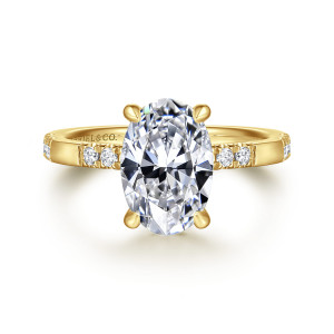Gabriel & Co. ER16716O8Y44JJ 14 karat yellow gold Contemporary engagement ring, front view of an oval center with round diamonds on each shoulder