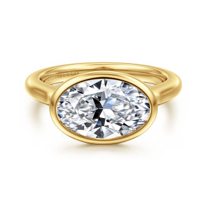Gabriel & Co. ER16717O12Y4JJJ 14 karat yellow gold Contemporary engagement ring, front view of a sideways oval center in a smooth bezel with a maker's mark inside the band
