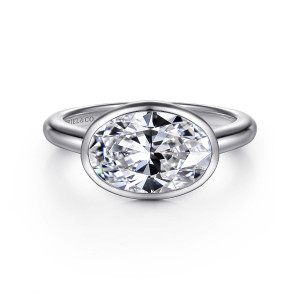 Gabriel & Co. ER16717O8W4JJJ 14 karat white gold Contemporary engagement ring, front view of a sideways oval center in a thin bezel on a plain rounded band